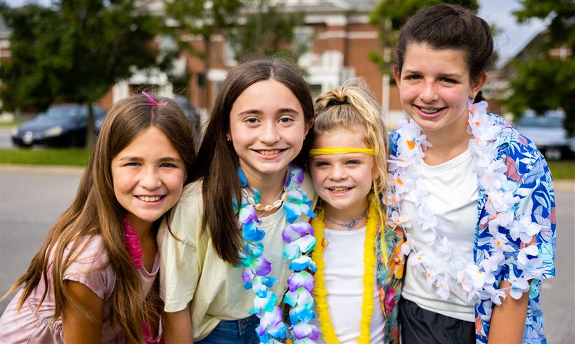 Four students smile